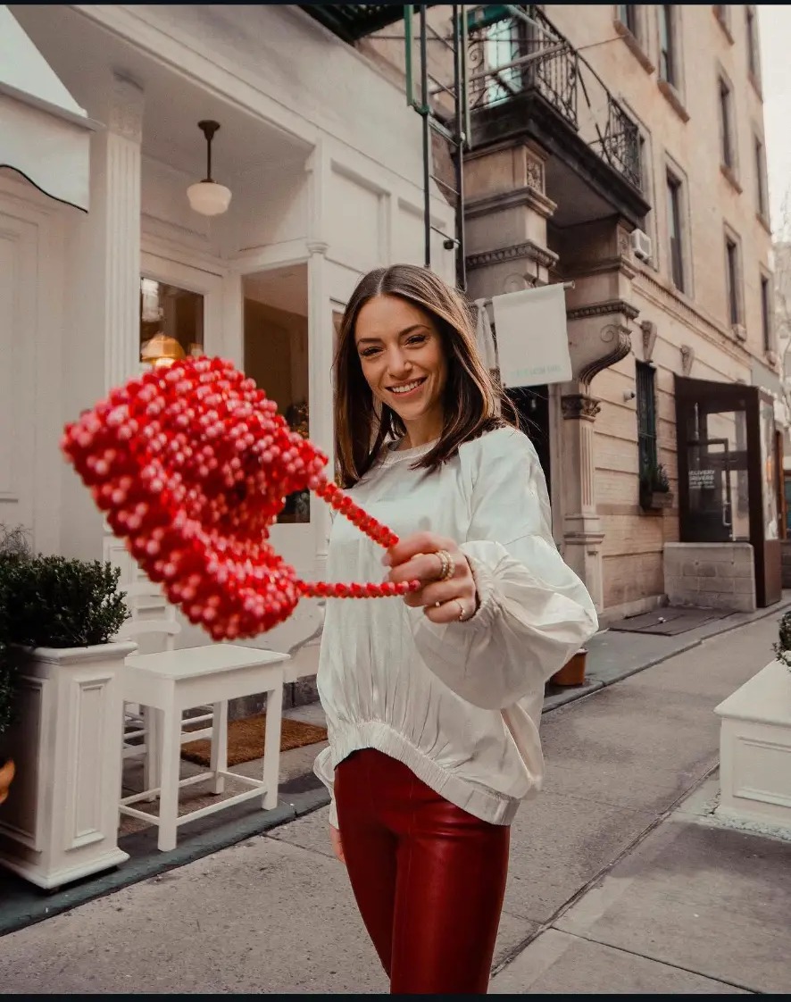 Haley Findlay holding a red heart on a New York street
